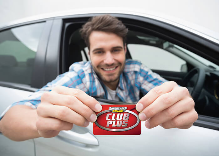 Customer holding Club Plus Card
